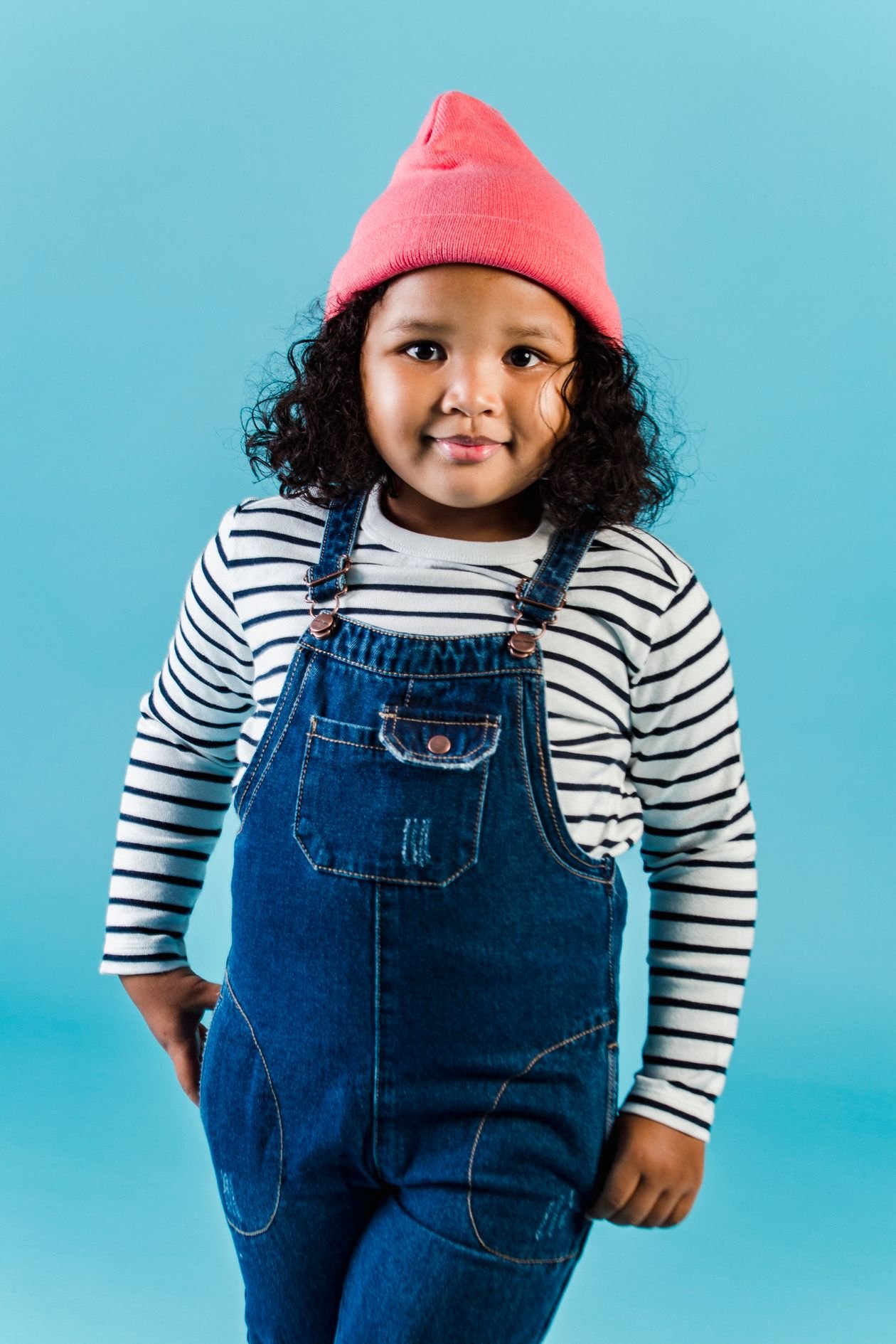 Child in a bright tailored outfit. Placeholder, not the garment.