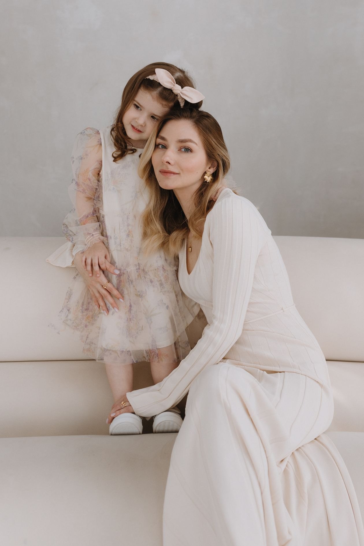 Mother and daughter in a studio portrait. Placeholder, not the garment.