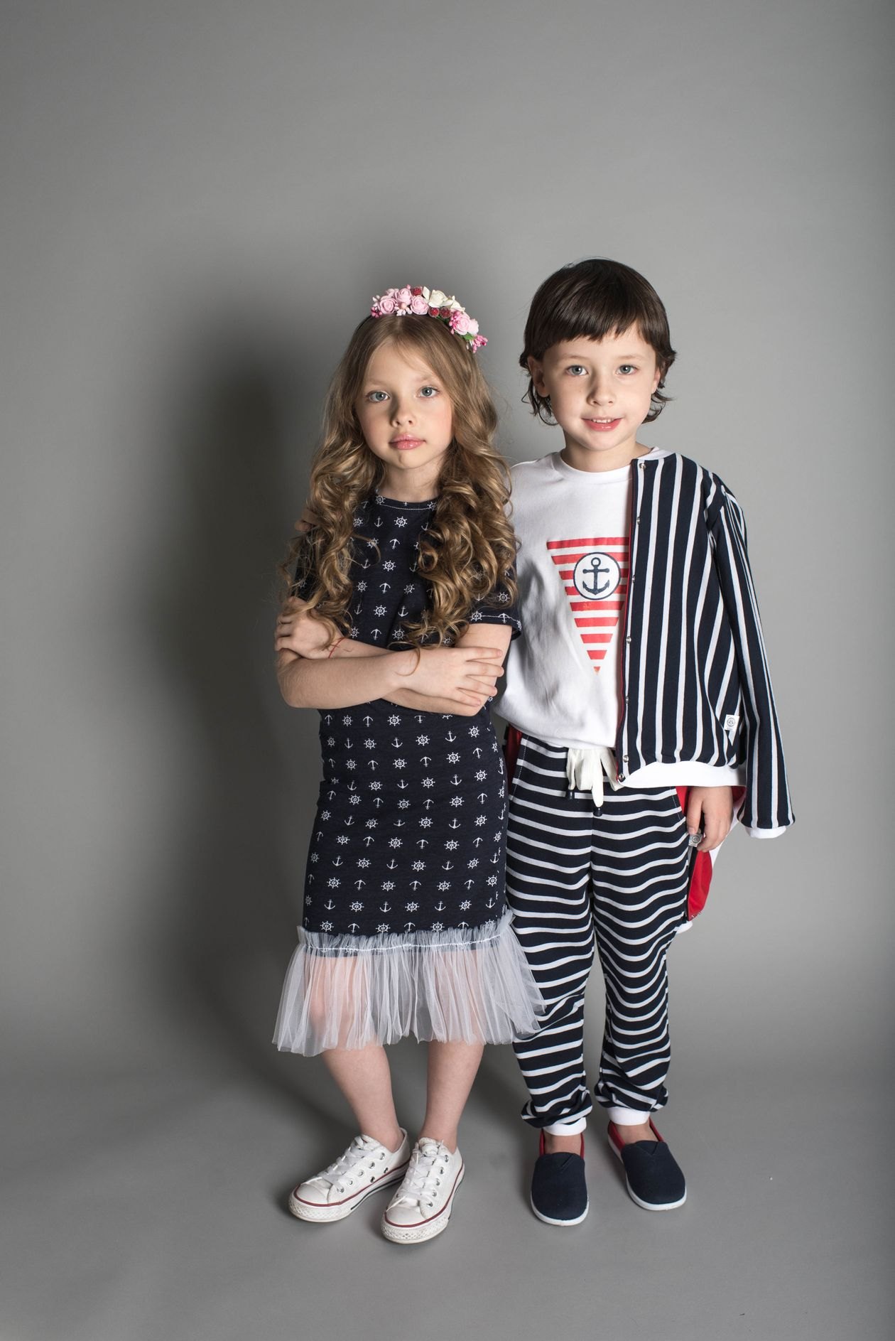 Little girl and boy in a studio portrait. Placeholder, not the garment.