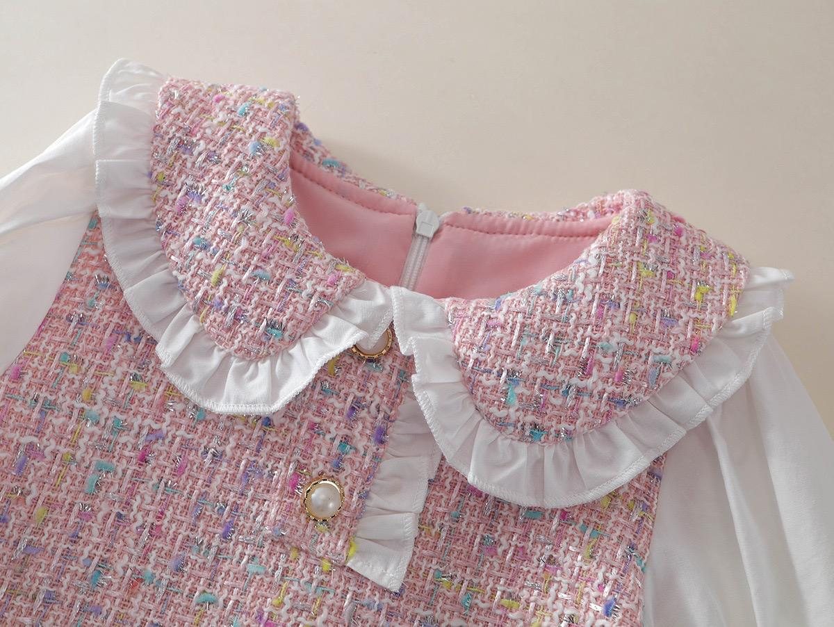 The Mabel Dress, ruffle collar, pearl button, and pink lining at the neck.