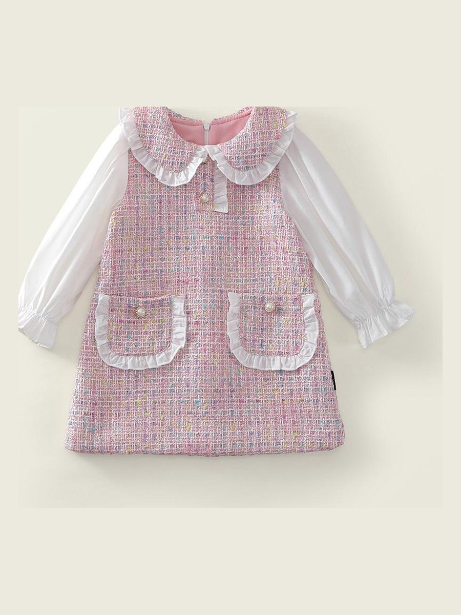 The Mabel Dress, a pink tweed pinafore and white blouse, laid flat.