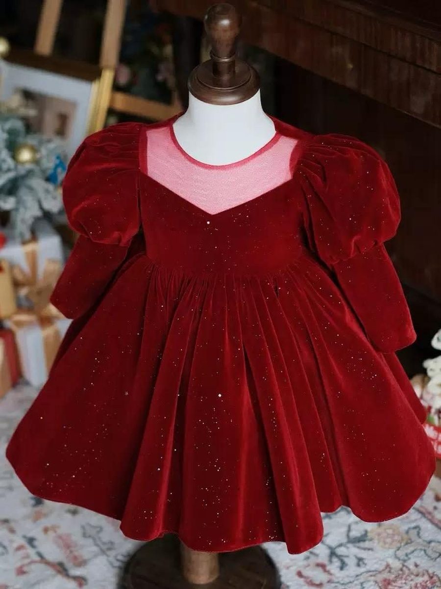 A red velvet dress, on a stand.