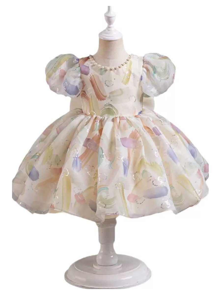 A watercolor-print dress, on a stand. Not one of the six named pieces.